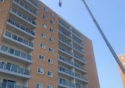 crane lifting equipment onto building roof